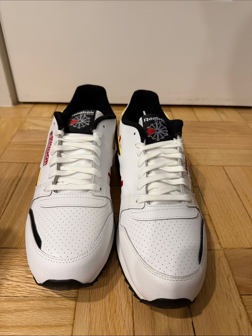 Reebok Men's White Sneakers with Black and Red Details and Yellow Logo